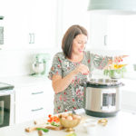 woman cooking with ultra instant pot in white kitchen
