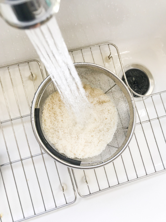 Instant Pot Steamer Basket rinsing rice under water