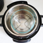 Instant Pot with a glass bowl and trivet inside the pot