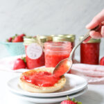 spoon of strawberry freezer jam on an english muffin