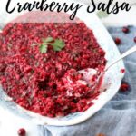 cranberry salsa and spoon on a large serving platter with text overlay
