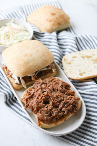 Instant Pot Freezer Meal BBQ Pulled Pork Sandwiches on a white plate